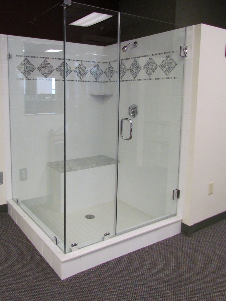 In our showroom we have a 3/8" Clear heavy glass shower, door and panel with a side return panel. Shower is coated with clear shield to prevent water staining. Stop by to see our other displays.